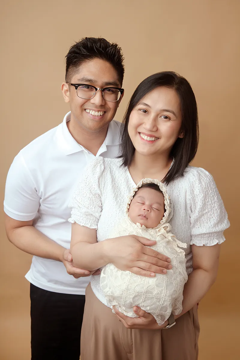 Parent holding child during family photography portrait session in Auckland
